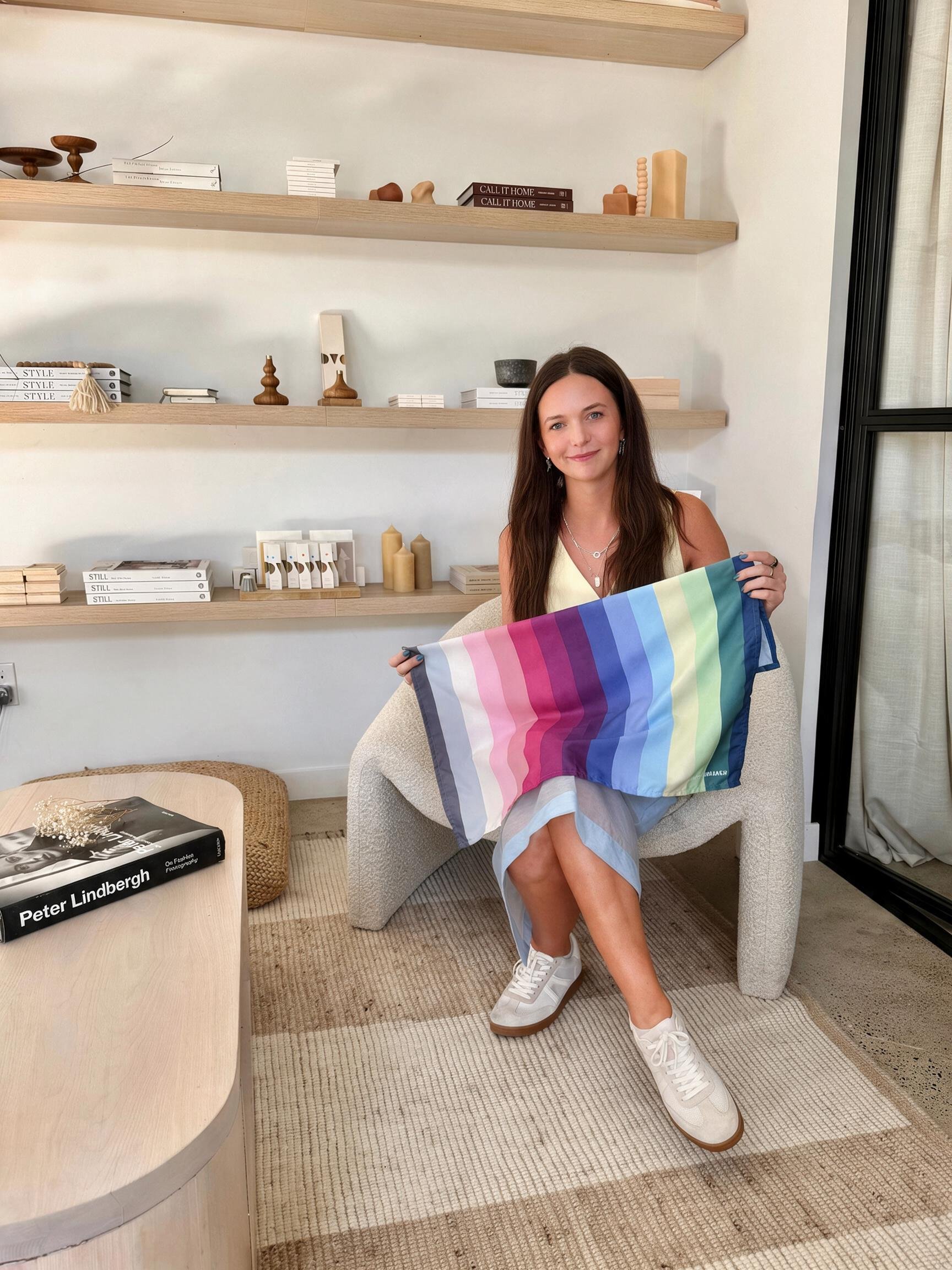 Nicole, certified color analyst and founder of The Stylery Colour Studio, holding a Summer palette drape in her St. Louis Park studio